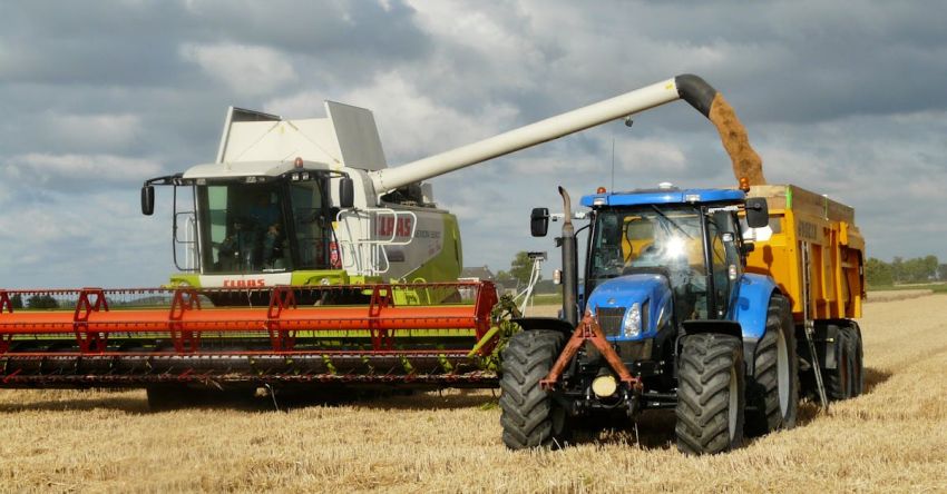 Tractors - Blue Tractor Next to White Farm Vehicle at Daytime