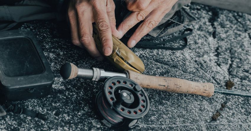 No-Till Equipment - A man is holding a fishing rod and a fishing reel