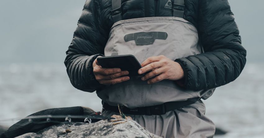 Tillage Equipment - A man in a fishing outfit holding a tablet