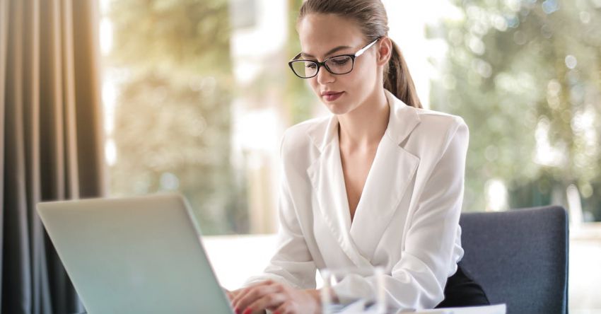 Smart Farming Technology - Concentrated female entrepreneur typing on laptop in workplace