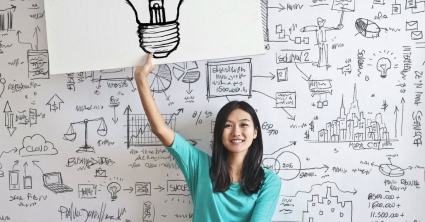 Agri-Tech Solutions - Woman Draw a Light bulb in White Board