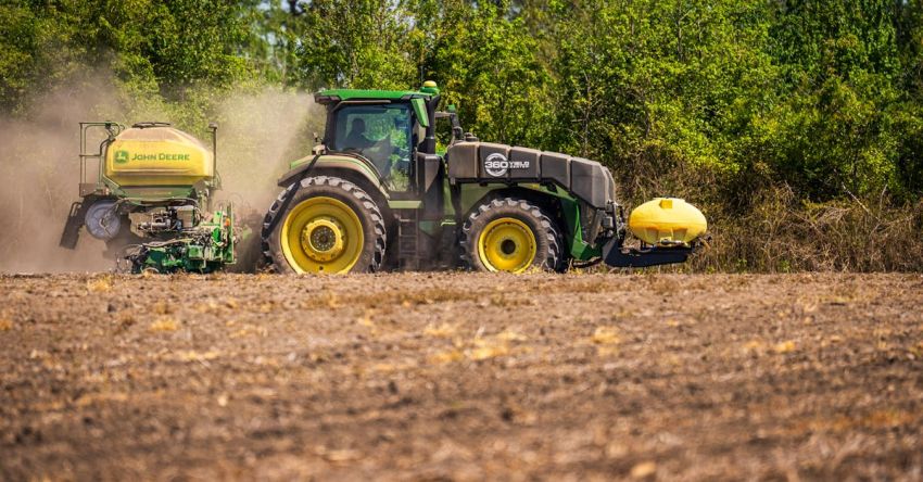 Plows - A tractor is spraying a field with fertilizer