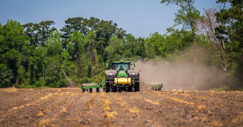 Plowing Tools - A tractor plowing a field with a green tractor