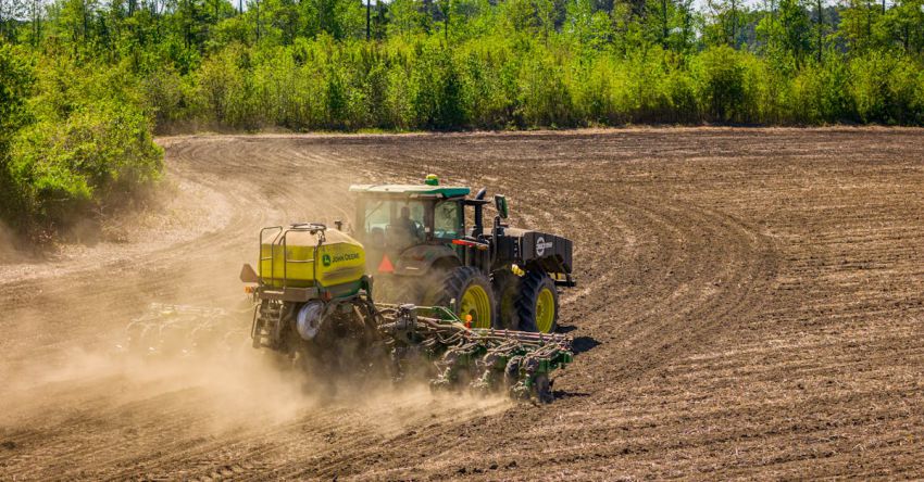 Plowing - A tractor is plowing the dirt in a field