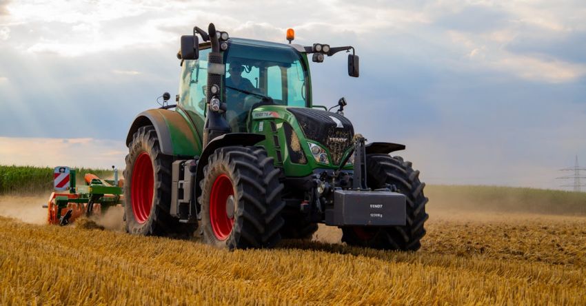 Tractors - Green Tractor Plowing The Fields on Focus Photography